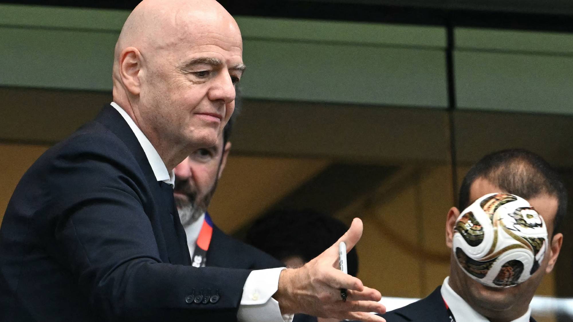 FIFA President Gianni Infantino (L) throws a replica match ball into the crowd at the end of the 2026 World Cup football tournament semi-final match between France and Spain at the Dallas Stadium in Arlington on July 14, 2026.